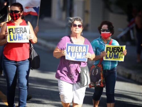 Manifestante con pancartas contra Luma Energy. 